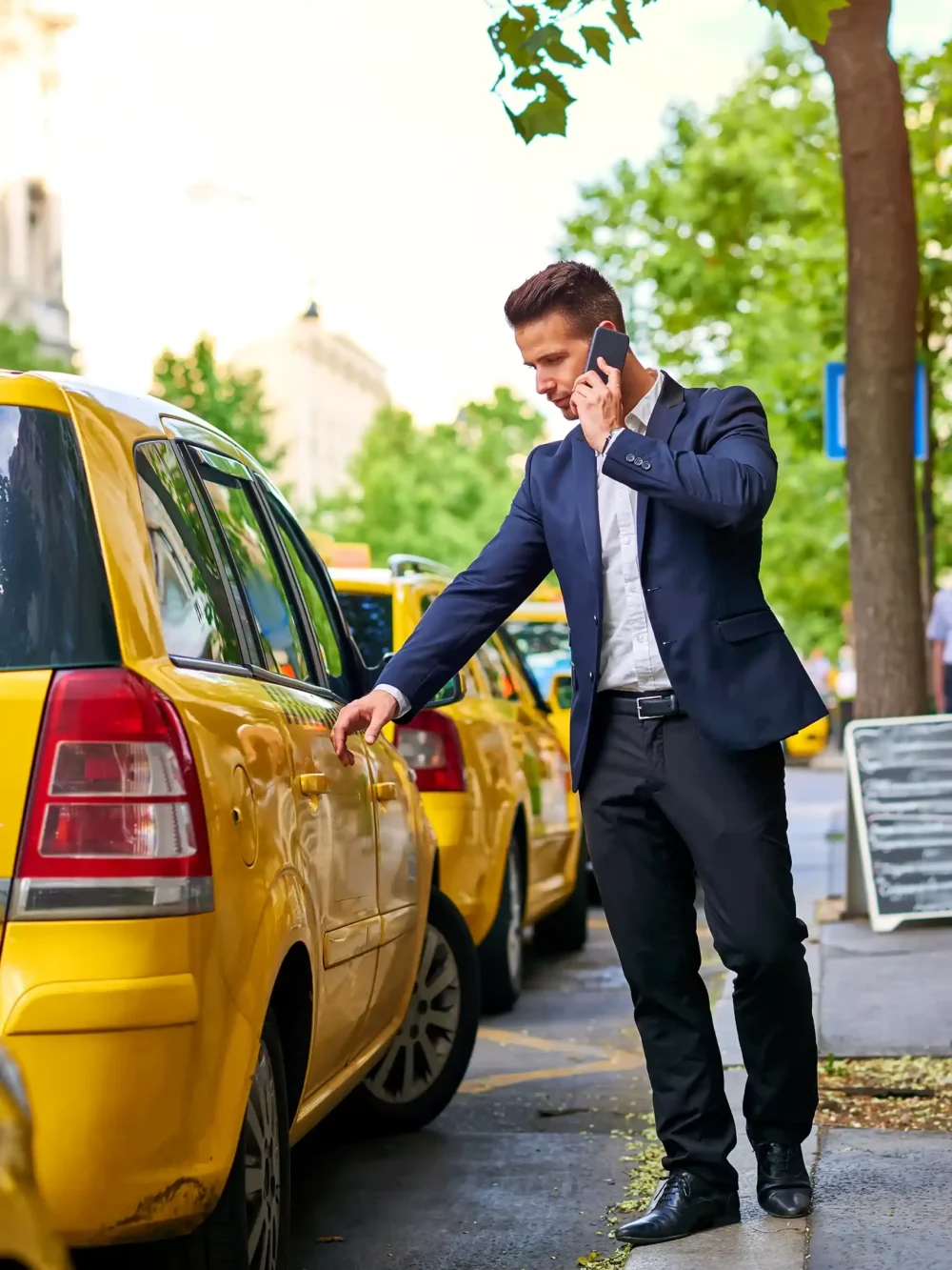 young-businessman-walking-taxi-talking-phone